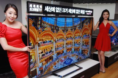 A side view of two models presenting the world’s first 84-inch Ultra Definition 3D TV by LG
