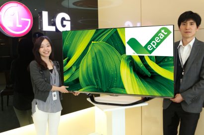 Two LG employees holding up an LG TV displaying the EPEAT logo