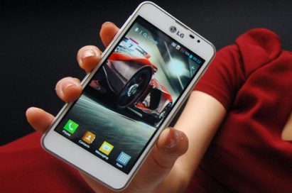 The LG Optimus F5 held by a model.