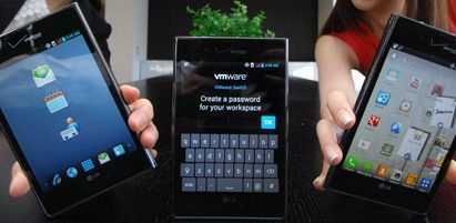 Three Optimus Vu:s showing different screens – two of them are held by models and the other one is displayed on a table.