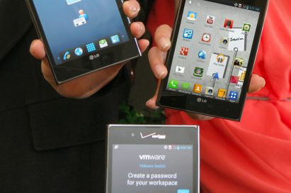 Three Optimus Vu:s showing different screens – two of them are held by models and the other one is displayed on a table.