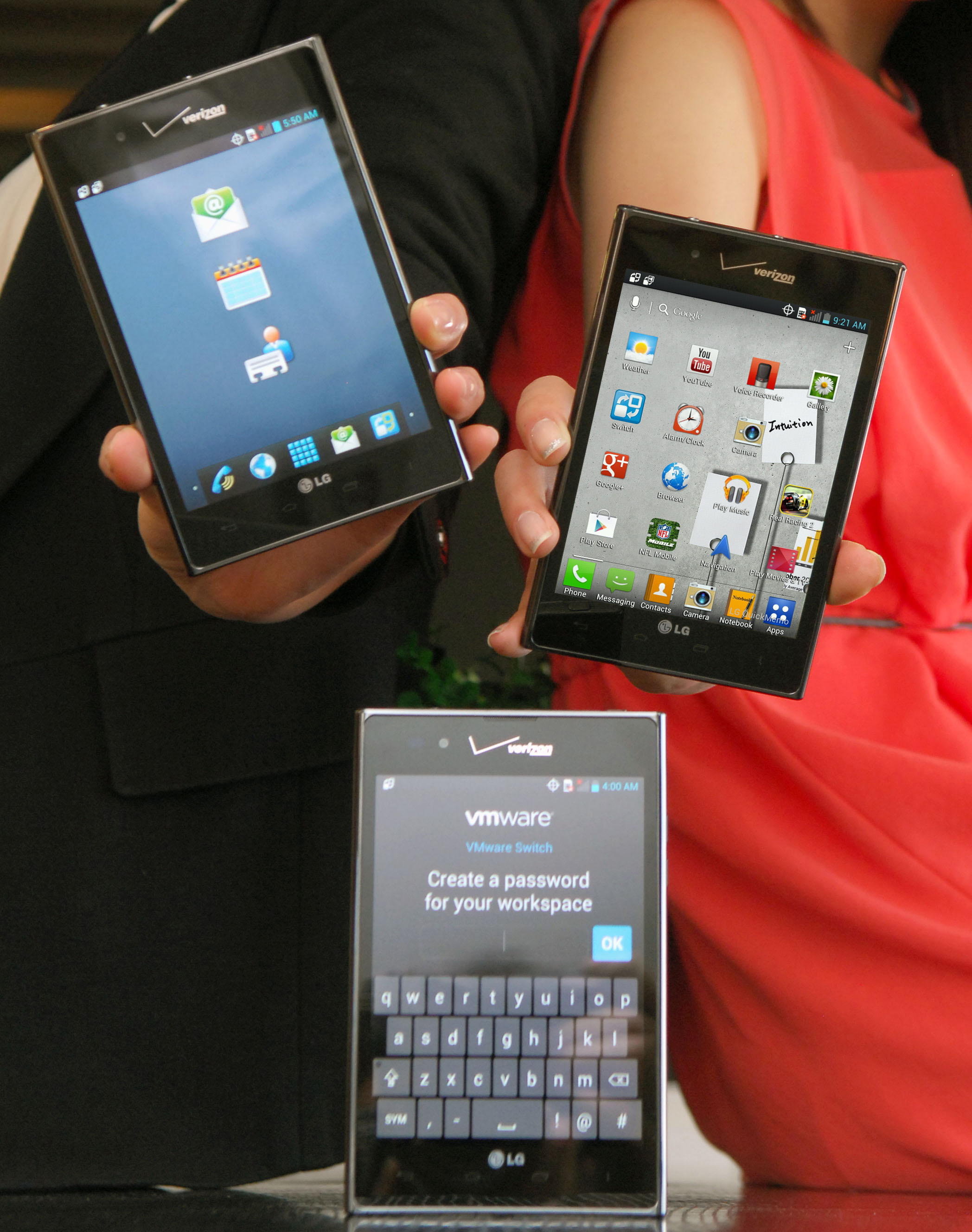 Three Optimus Vu:s showing different screens – two of them are held by models and the other one is displayed on a table.