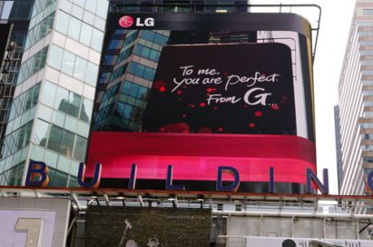 A Times Square billboard saying “To me, you are perfect. From G”