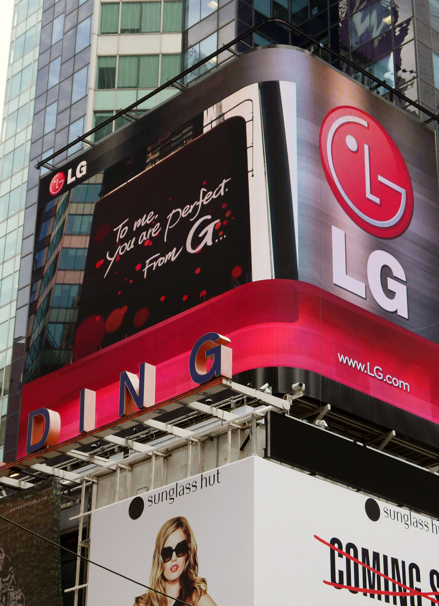 A Times Square billboard saying “To me, you are perfect. From G”