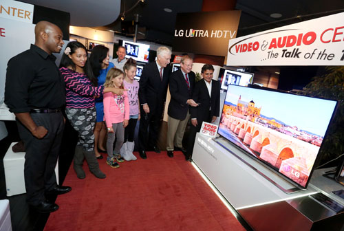 Visitors look at the LG Ultra HD TV model LA9700 on display at the Video&Audio Center.