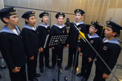 Members of the Vienna Boys’ Choir recording songs through the LG G2.