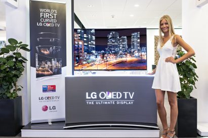 A model is demonstrating LG CURVED OLED TV model 55EA9800
