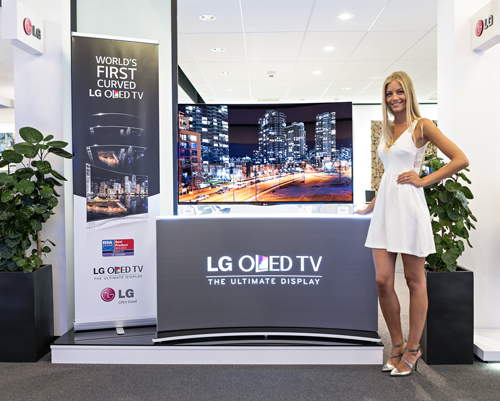 A model is demonstrating LG CURVED OLED TV model 55EA9800.