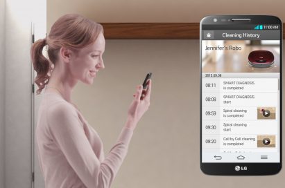 A woman monitoring her LG HOM-BOT’s cleaning history with the smart app