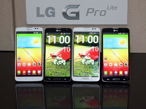 Front views of four LG G Pro Lites displayed upright on a table, with an “ LG G Pro Lite” logo attached to the wall behind.