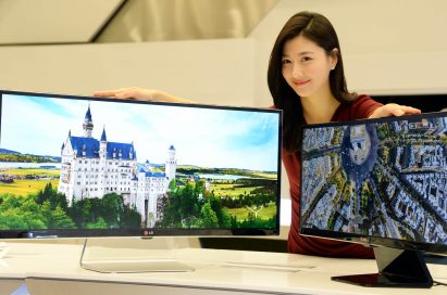 A model presenting the 34-inch and 29-inch IPS 21:9 UltraWide monitors while putting her hands on both