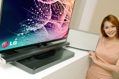 A model posing with LG’s advanced audio video lineup at 2014 CES