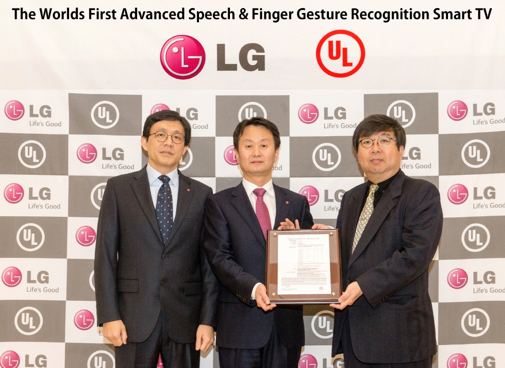 Three officials from LG and UL (Underwriters Laboratories) hold up a validation certificate from UL