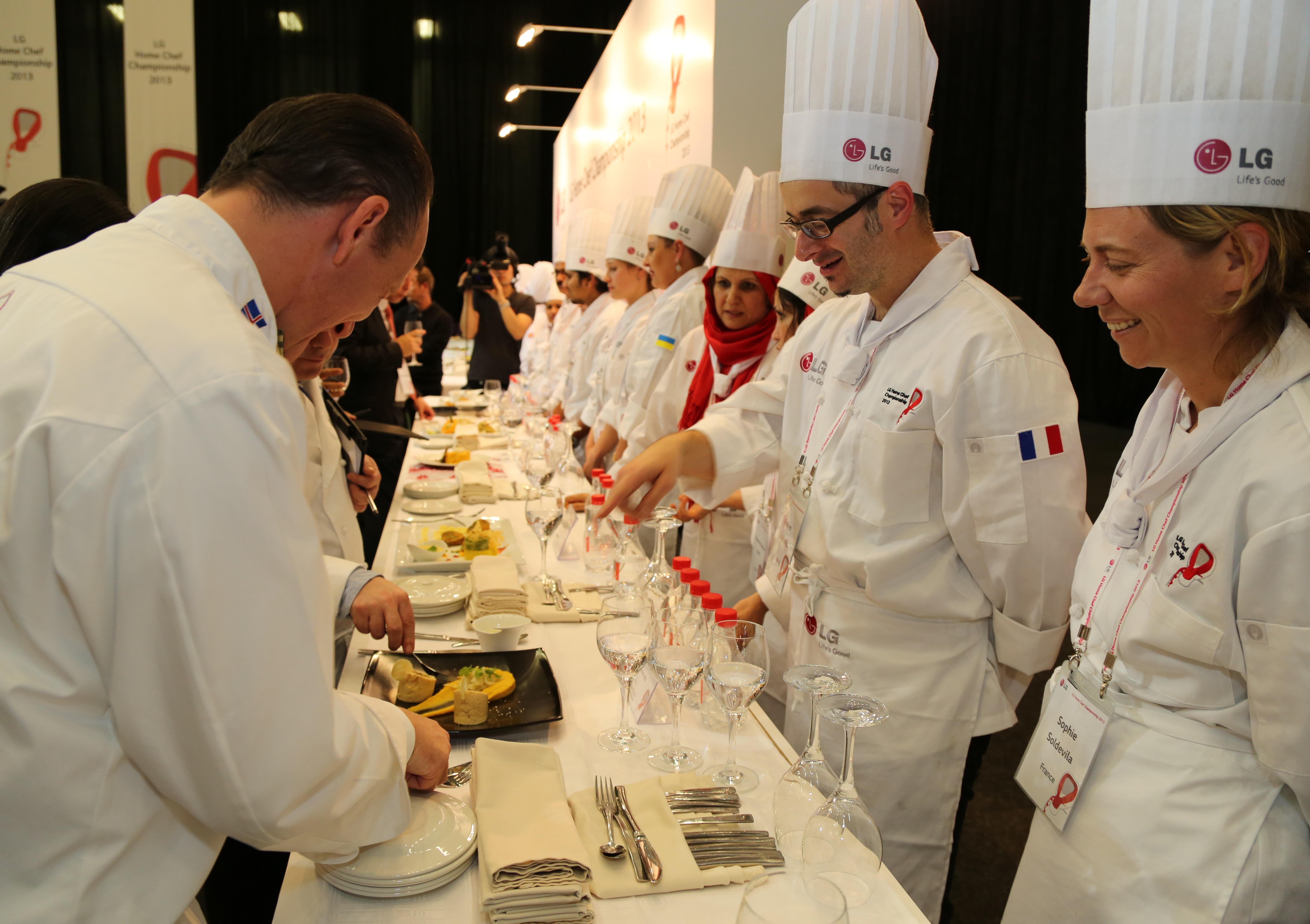 Participating chefs explain their dishes to the judges