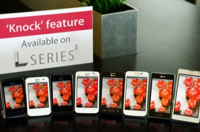 A panel saying “’Knock’ feature Available on SERIES” is standing on a table in front of various LG smartphones.