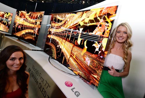 Two models showcasing the world’s first Flexible OLED TV by LG at CES 2014.