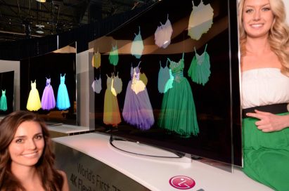 Two models showcasing the world’s first Flexible OLED TV by LG at CES 2014