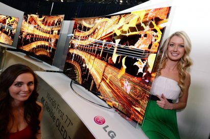 Two models showcasing the world’s first Flexible OLED TV by LG at CES 2014