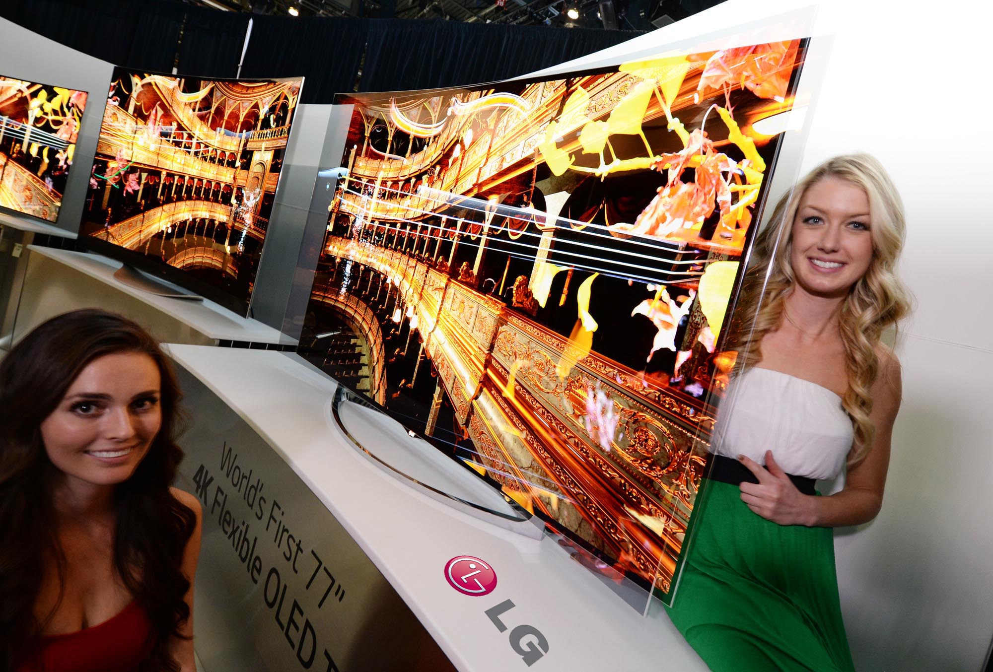 Two models showcasing the world’s first Flexible OLED TV by LG at CES 2014
