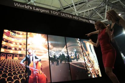 Two models demonstrating LG’s 98-inch ULTRA HD display at ISE2014