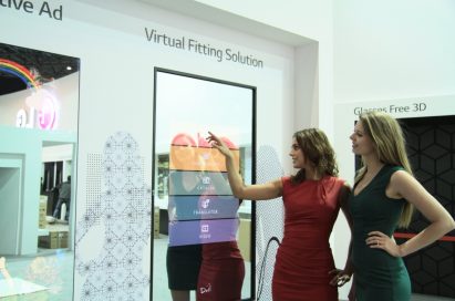 Two models demonstrating the Virtual Fitting solution available on LG’s 55-inch Fulll HDLG Board at ISE2014