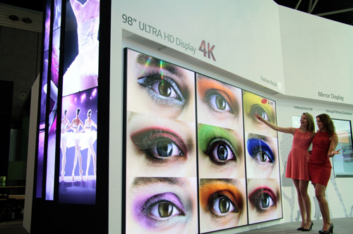 Two models demonstrating LG’s 98-inch ULTRA HD display at ISE2014.