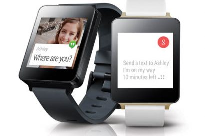 A front and side view of the LG G Watch in Titan Black and White showing the user replying to a text message with the watch’s text feature.