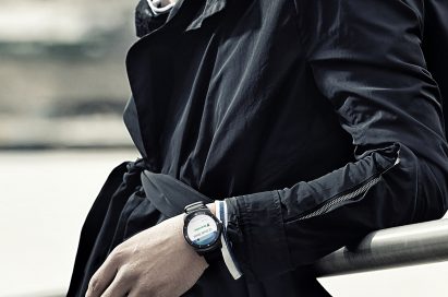 A man wearing the LG G Watch R. as he leans over a rail.