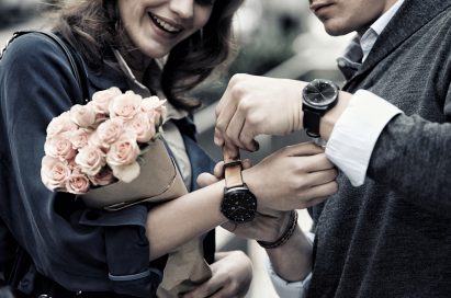 A man wearing the LG G Watch R as he puts another LG G Watch R on his girlfriend’s wrist.
