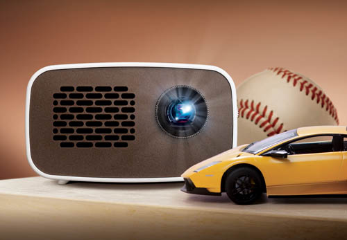 Front view of LG HD MiniBeam model PH300 beaming light on a table next to images of a baseball and supercar.