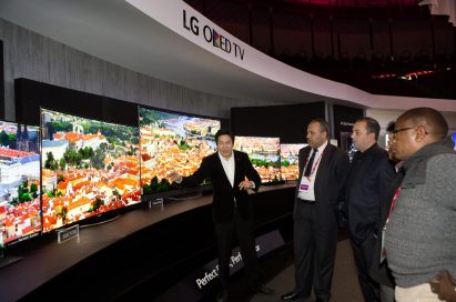 A guide explains the LG's flashship 4K OLED TV lineup to visitors.