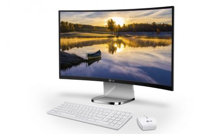 A right-side view of LG’s curved All-In-One PC model 29V950 with a keyboard and mouse at its front