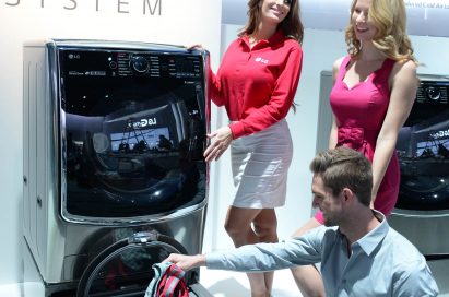 Male and female models posing next to LG TWINWash™ washing machine. A male putting a small laundry into the Mini washer.