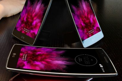 Two LG G Flex2s are standing on the table showing their fronts and other twos are lying on the table – each showing front and back.