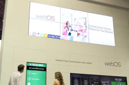 Two models taking a closer look at LG Smart Platform Signage with webOS at ISE 2015