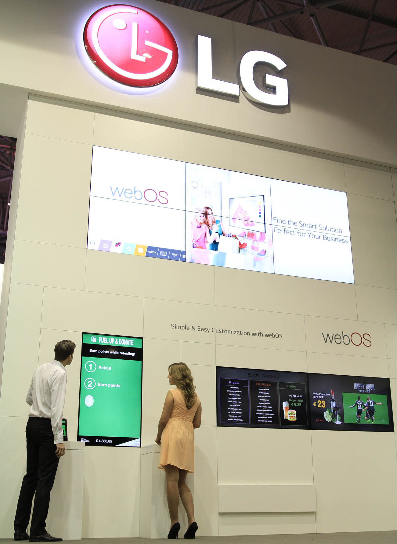 Two models taking a closer look at LG Smart Platform Signage with webOS at ISE 2015