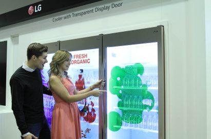 Two models opening LG’s Transparent Display Cooler Door at ISE 2015