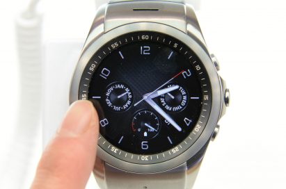 A finger approaching to a LG Watch Urbane.