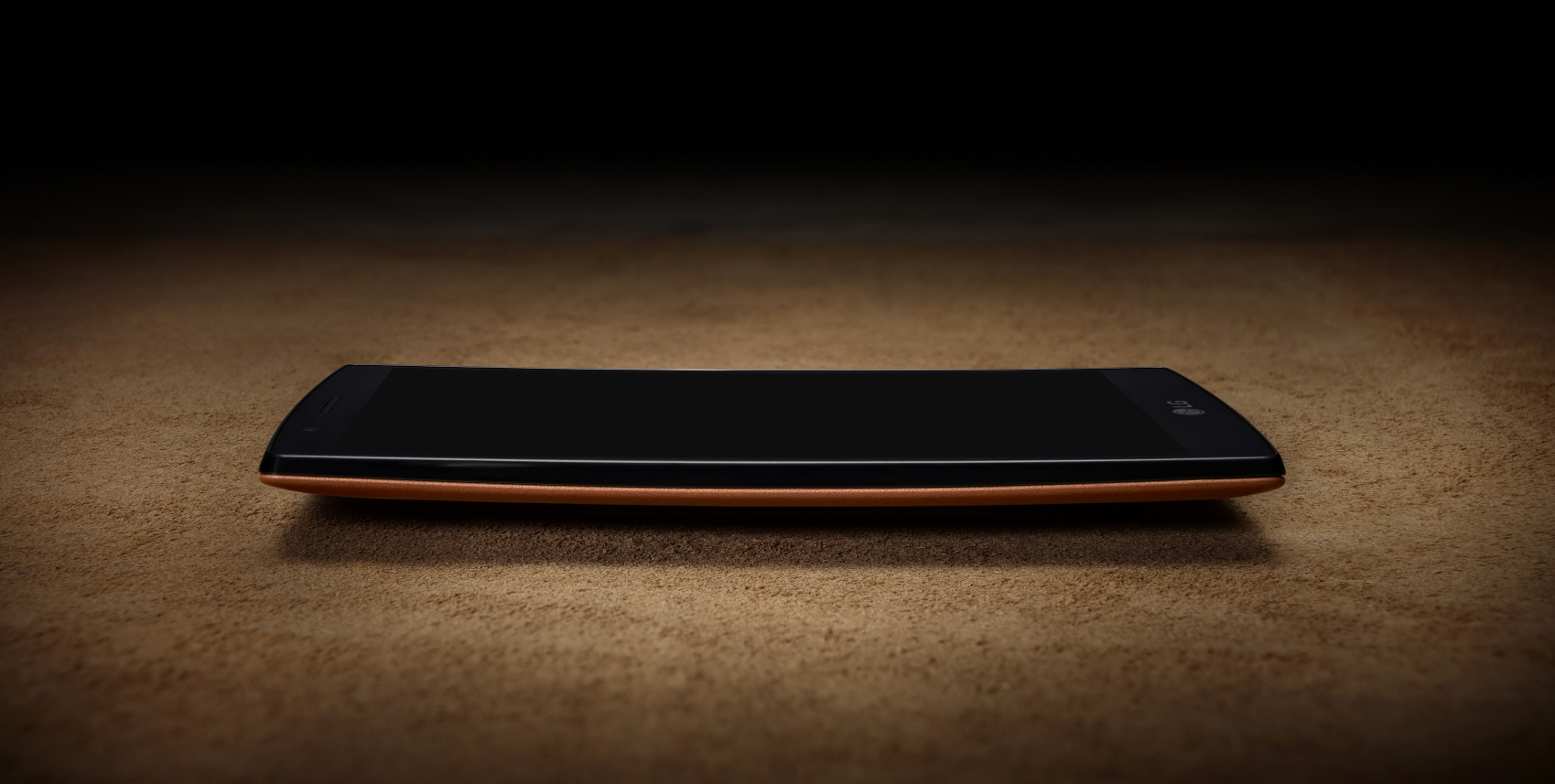 A side vie of the LG G4 wearing a brown leather when lying on a table.