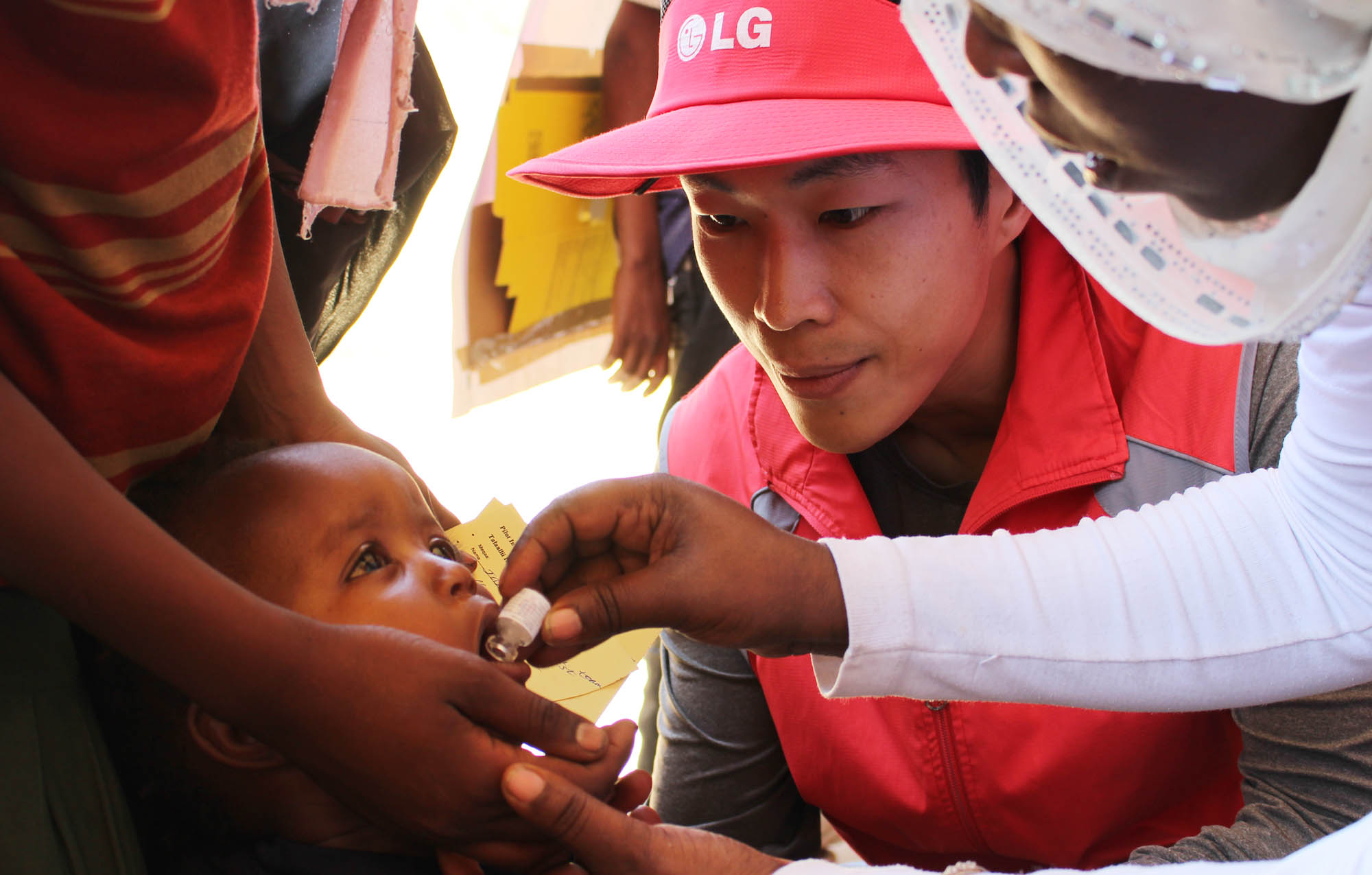 A child gets an oral cholera vaccination.