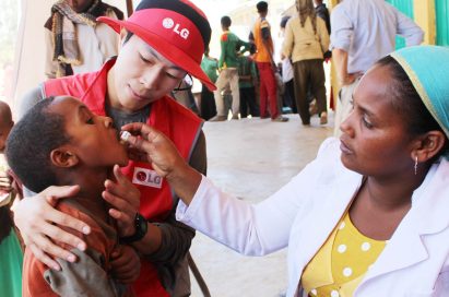 A child gets an oral cholera vaccination.