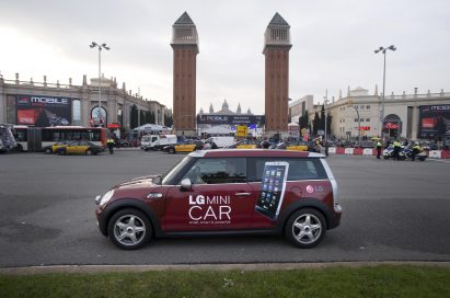 The LG Mini car drives past the Venetian Towers at Plaza España, Barcelona.