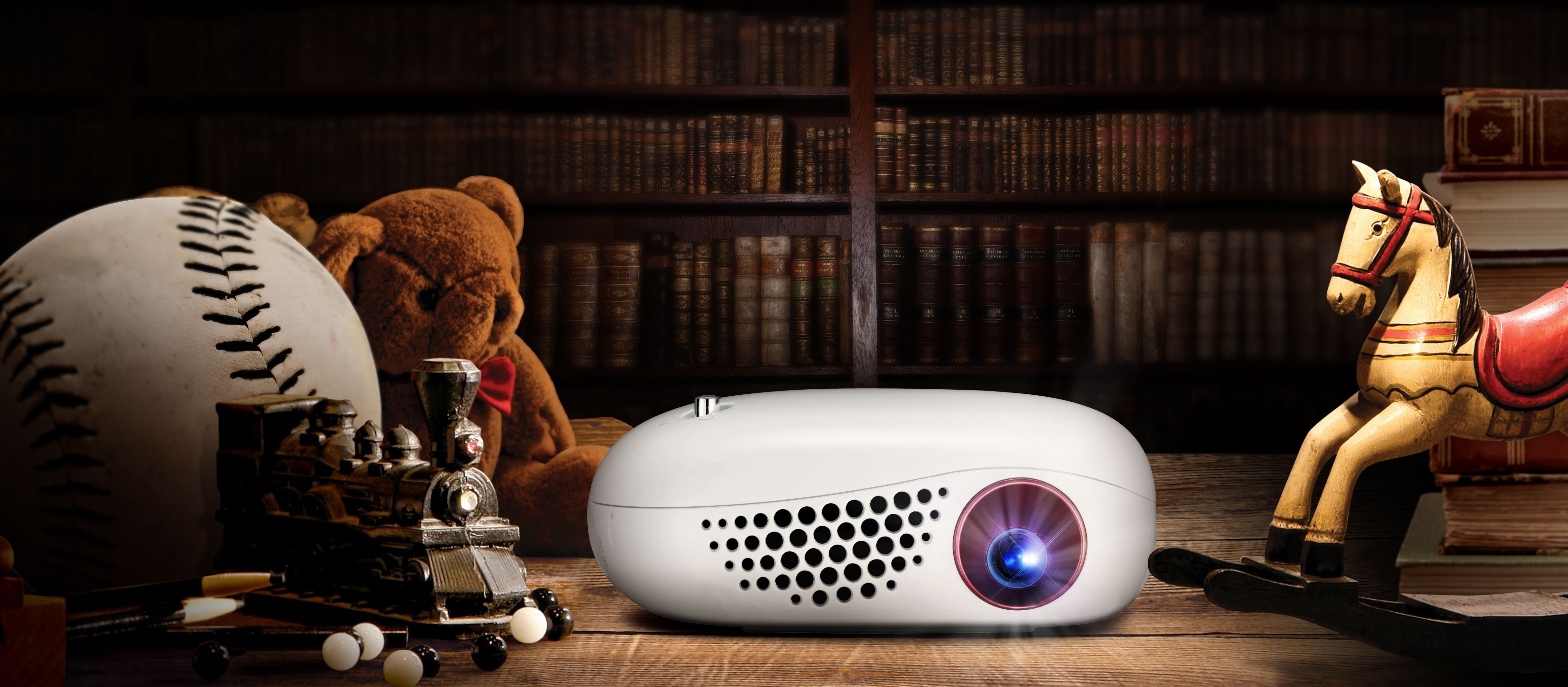 Front view of LG MiniBeam Nano sitting on desk in a dark room
