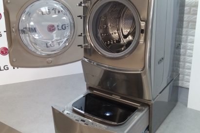 LG TWINWash™ washing machine in gray color with front-load on the top and top-load at the bottom. Both washers are opened.