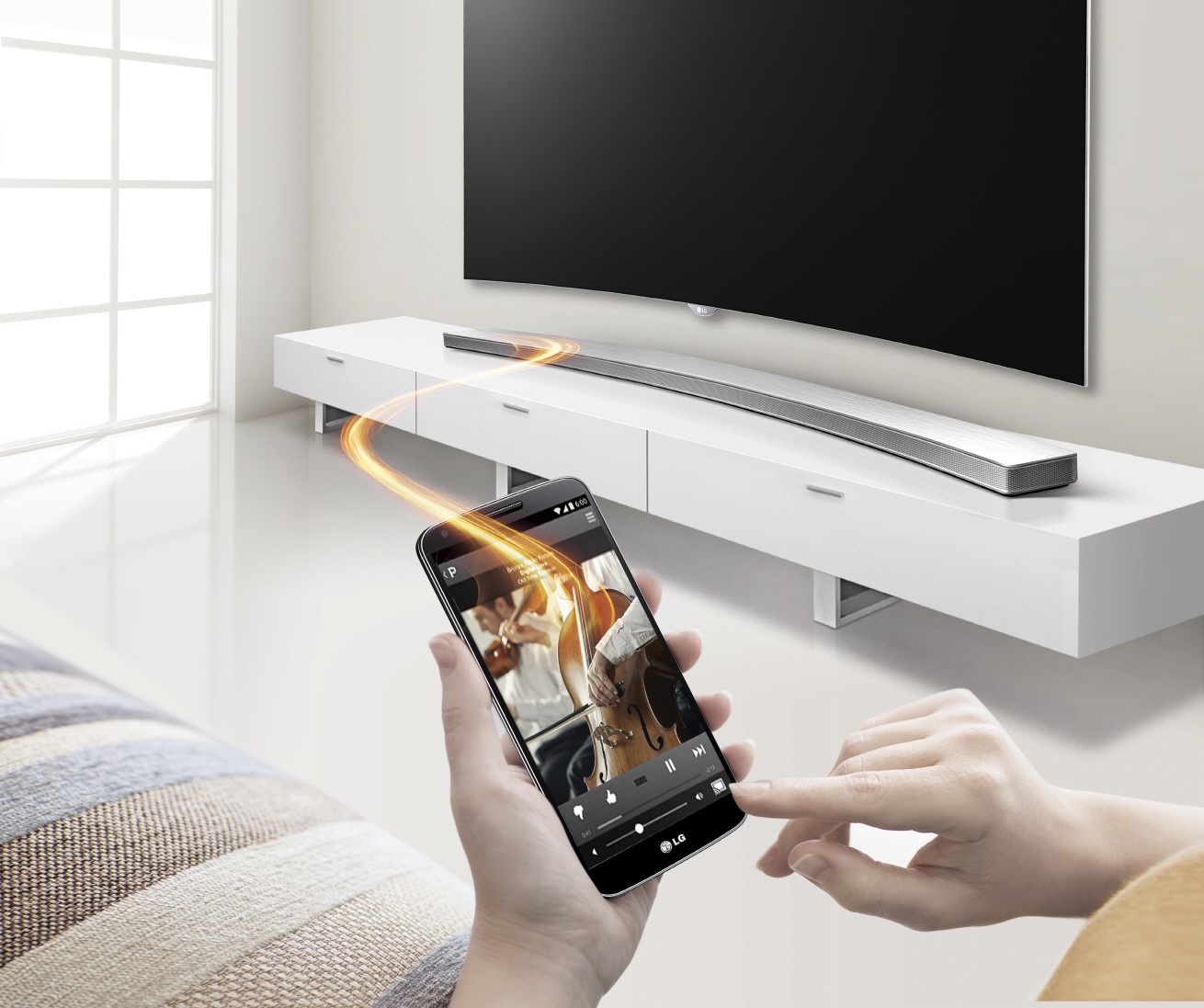 Front view of the LG Curved Sound Bar with a model controlling it via the Soundbar Smartphone App Controller
