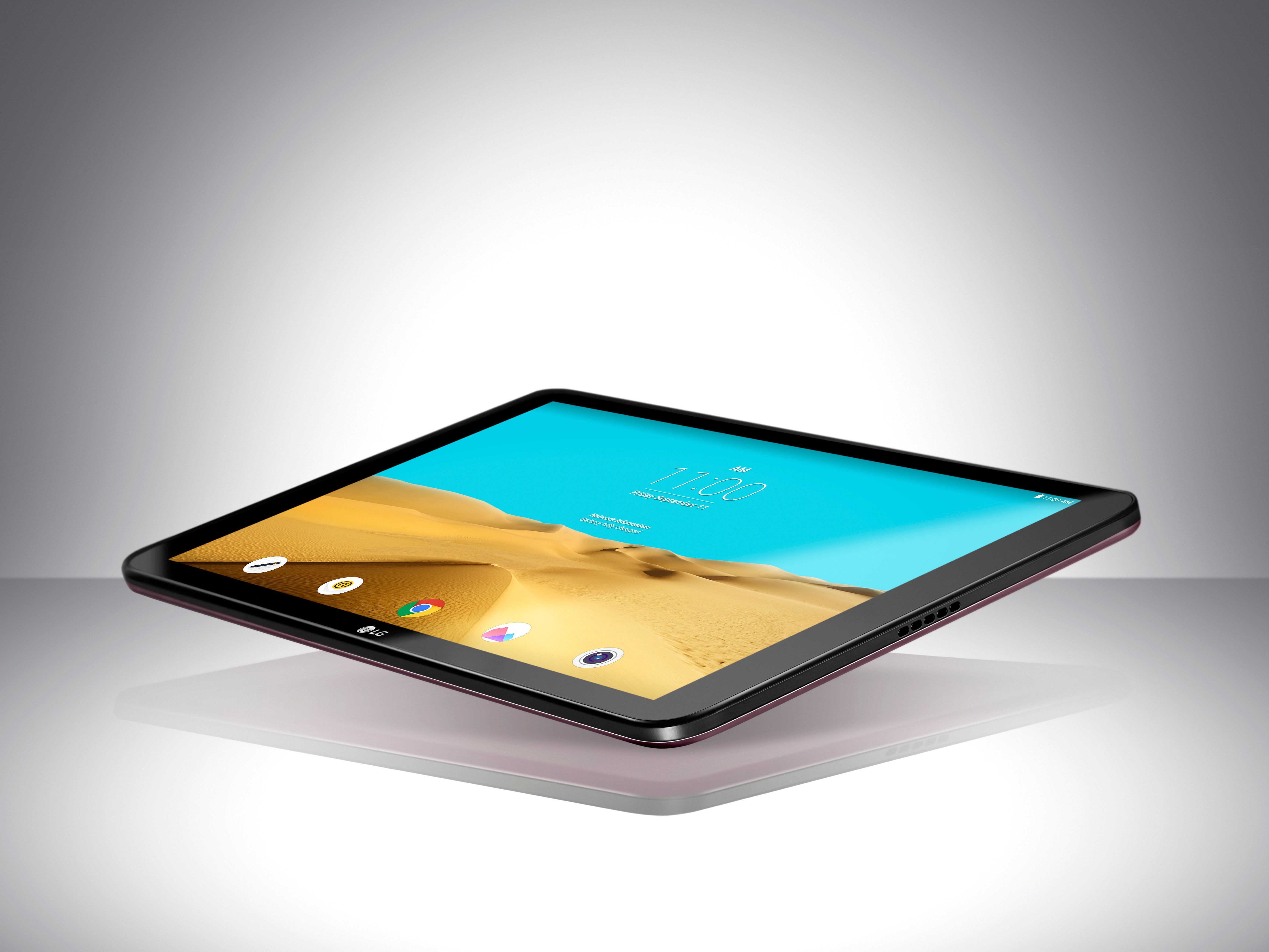 A LG Pad II 10.1 is floating in the air with its screen on above a table.