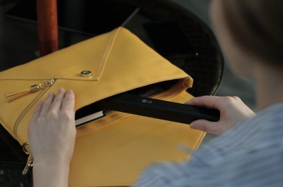 A woman putting her Rolly Keyboard in her purse.