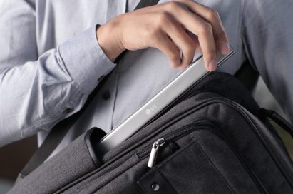 A man taking his folded Rolly Keyboard out of the side pocket of his backpack.
