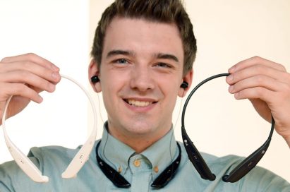 A man wearing a TONE ULTRA HBS-810 holds two more TONE ULTRA HBS-810s in black and white.