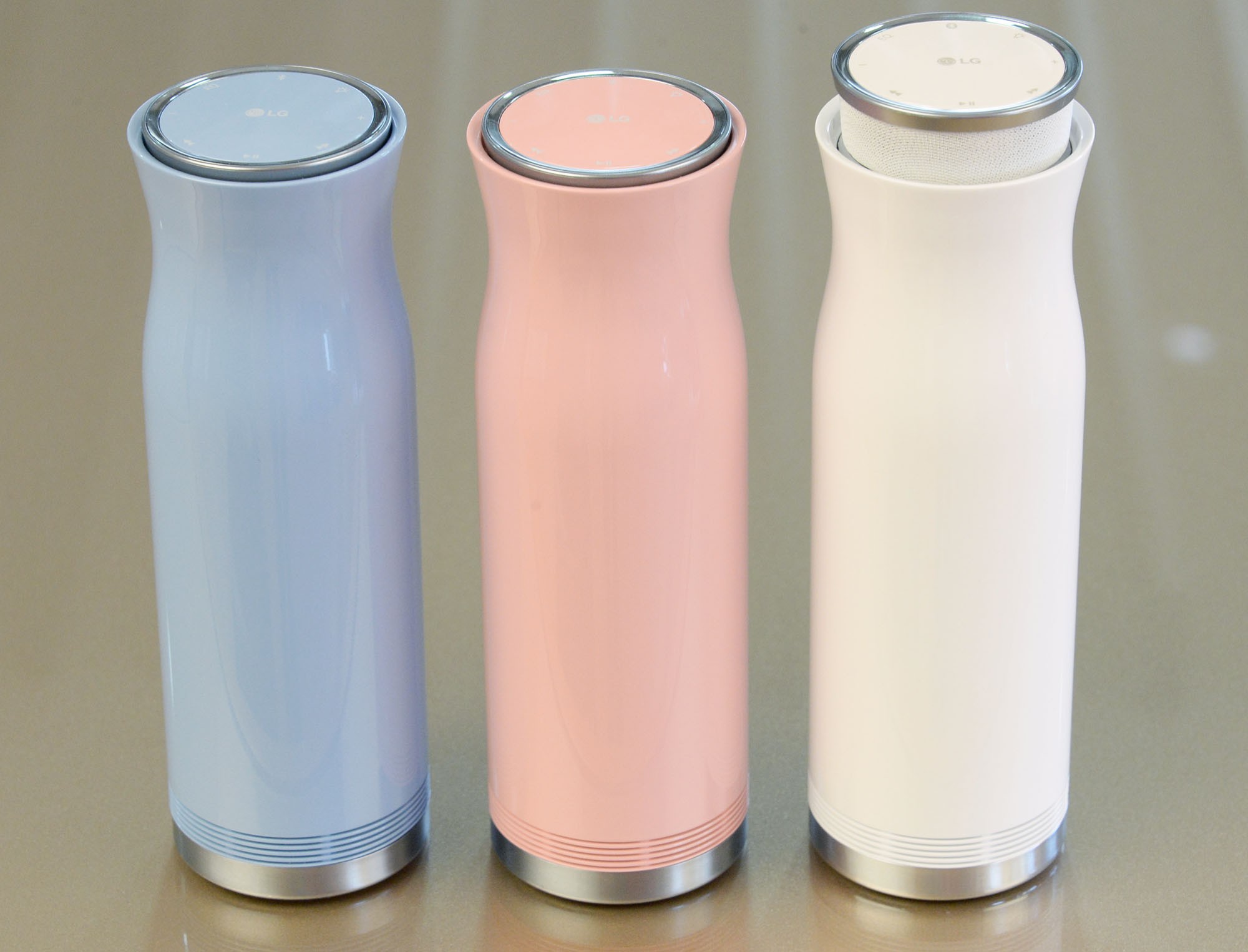 Three side-by-side LG SoundPop 360 models in pink, white and light blue